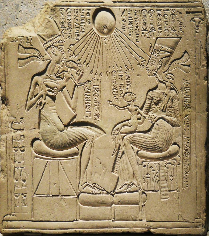 The Egyptian sun god Aten lowers his hands of rays on Akhenaten and Nefertiti with three children. Public Domain